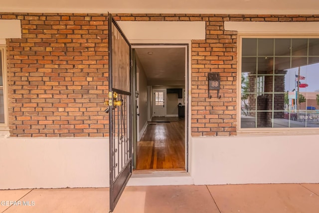 view of exterior entry with brick siding