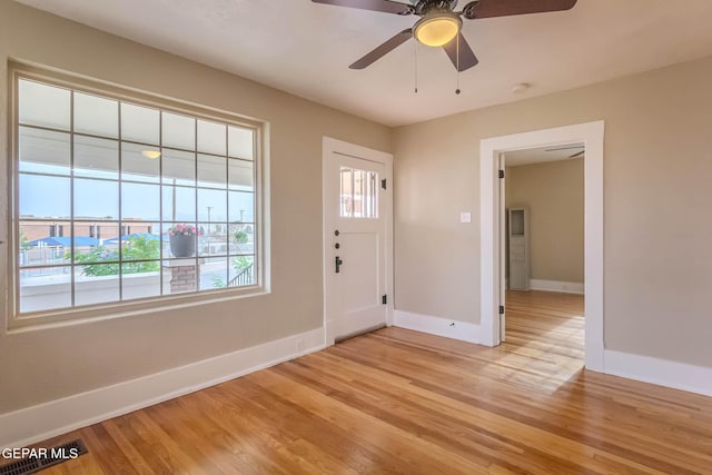 entryway with light wood-style floors, baseboards, and ceiling fan