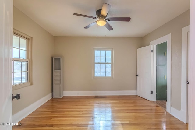 unfurnished bedroom featuring baseboards, a ceiling fan, and light wood finished floors