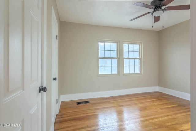 unfurnished room with visible vents, light wood-style flooring, ceiling fan, and baseboards