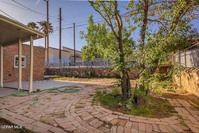 view of yard featuring fence and a patio