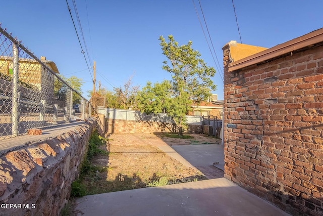view of yard featuring fence and a patio area