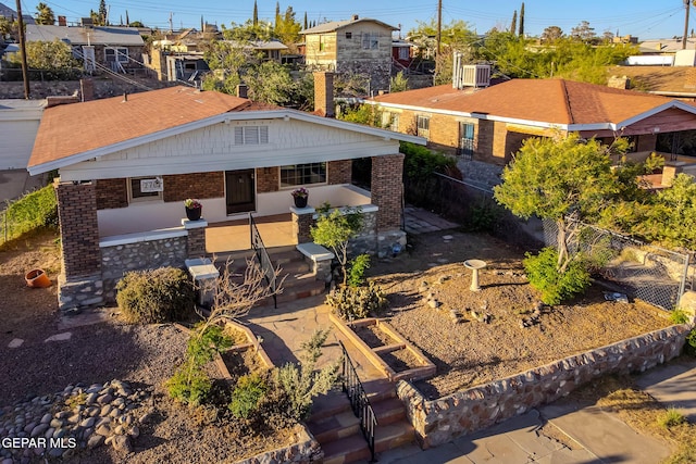 exterior space with brick siding, fence, a residential view, and a patio