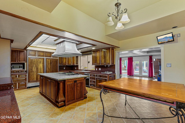 624 Mount Cristo Rey Ln, El Paso, TX 79922 - kitchen with island range hood, french doors, decorative backsplash, a chandelier, and a kitchen island