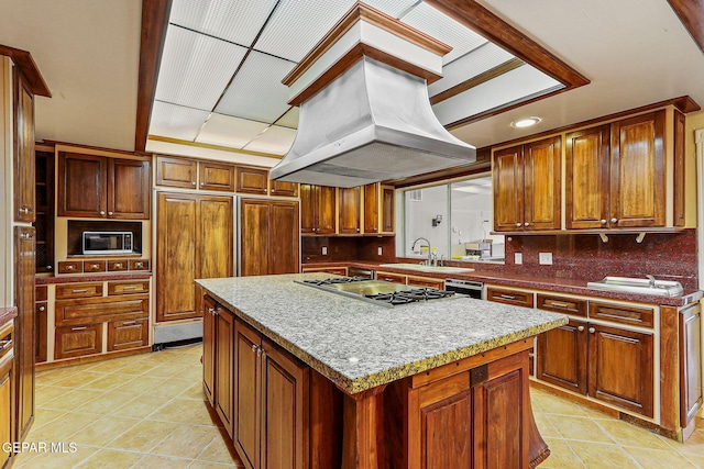 624 Mount Cristo Rey Ln, El Paso, TX 79922 - kitchen with a sink, cooktop, a center island, light tile patterned floors, and decorative backsplash