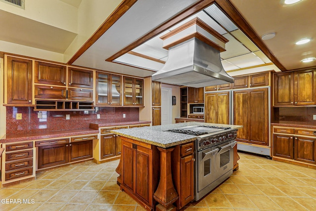 624 Mount Cristo Rey Ln, El Paso, TX 79922 - kitchen featuring range with two ovens, built in microwave, island exhaust hood, tasteful backsplash, and recessed lighting