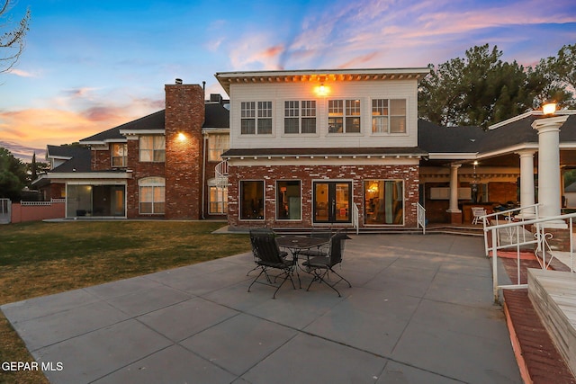 624 Mount Cristo Rey Ln, El Paso, TX 79922 - rear view of house featuring a patio area, a yard, brick siding, and a chimney