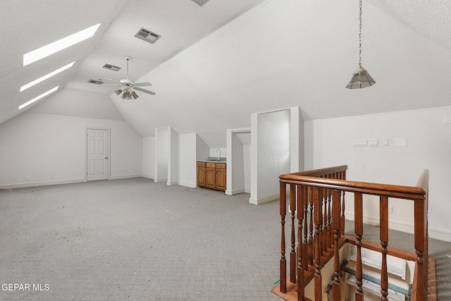 624 Mount Cristo Rey Ln, El Paso, TX 79922 - bonus room featuring lofted ceiling, baseboards, ceiling fan, a skylight, and light colored carpet