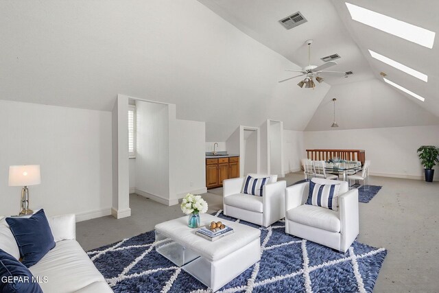 624 Mount Cristo Rey Ln, El Paso, TX 79922 - living area featuring vaulted ceiling, a skylight, a ceiling fan, baseboards, and light carpet