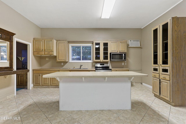 624 Mount Cristo Rey Ln, El Paso, TX 79922 - kitchen featuring stainless steel appliances, a sink, light countertops, a center island, and glass insert cabinets