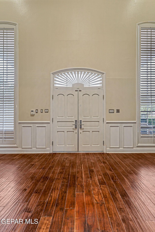 624 Mount Cristo Rey Ln, El Paso, TX 79922 - foyer entrance with dark wood-type flooring, a wainscoted wall, and a decorative wall