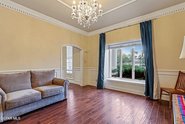 624 Mount Cristo Rey Ln, El Paso, TX 79922 - living room featuring arched walkways, wainscoting, ornamental molding, a chandelier, and dark wood finished floors