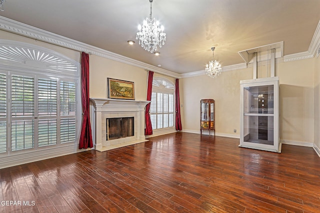 624 Mount Cristo Rey Ln, El Paso, TX 79922 - unfurnished living room with a chandelier, a fireplace, wood-type flooring, baseboards, and ornamental molding