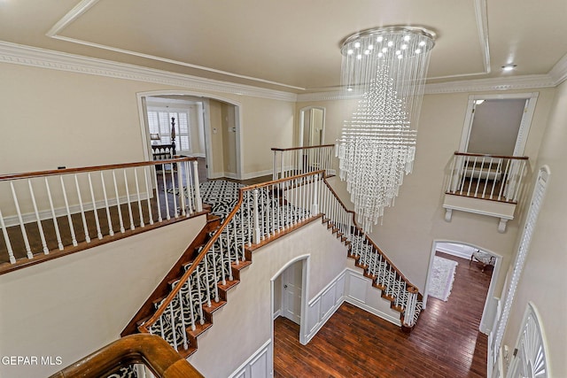 624 Mount Cristo Rey Ln, El Paso, TX 79922 - stairs with arched walkways, wood finished floors, a chandelier, and ornamental molding