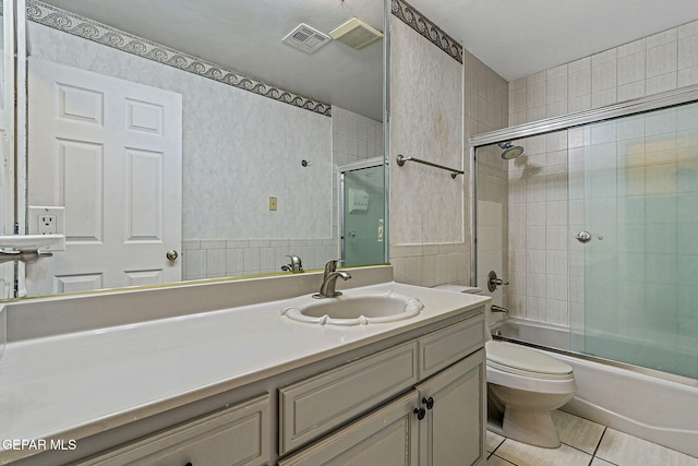 624 Mount Cristo Rey Ln, El Paso, TX 79922 - bathroom with tile patterned flooring, toilet, wallpapered walls, bath / shower combo with glass door, and vanity