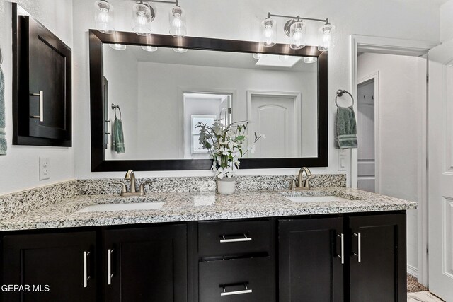bathroom with double vanity and a sink