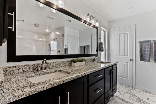 full bathroom with visible vents, a sink, marble finish floor, and a shower stall