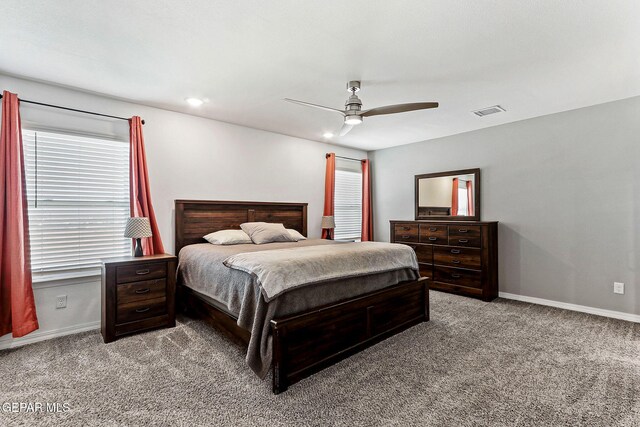 carpeted bedroom with baseboards, ceiling fan, and visible vents