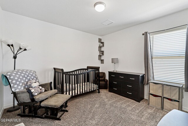 bedroom featuring baseboards, visible vents, and light carpet