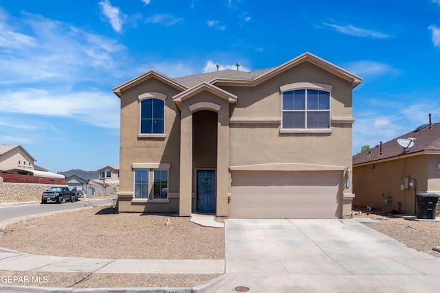 view of front of home featuring an attached garage, stucco siding, and concrete driveway