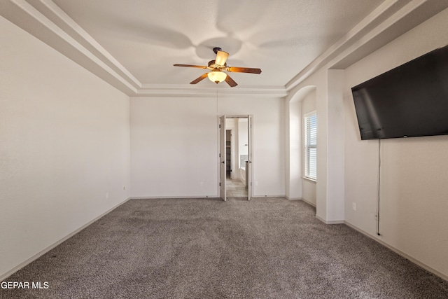 interior space with carpet floors, a ceiling fan, and baseboards