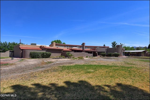 5401 Tierra Vista Dr, El Paso, TX 79932 - view of front facade featuring a tiled roof, stucco siding, and a front yard