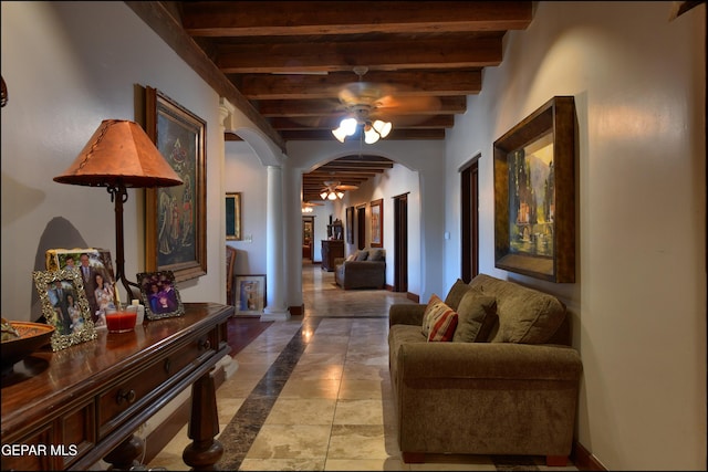 5401 Tierra Vista Dr, El Paso, TX 79932 - hallway featuring arched walkways, decorative columns, baseboards, and wooden ceiling with exposed beams