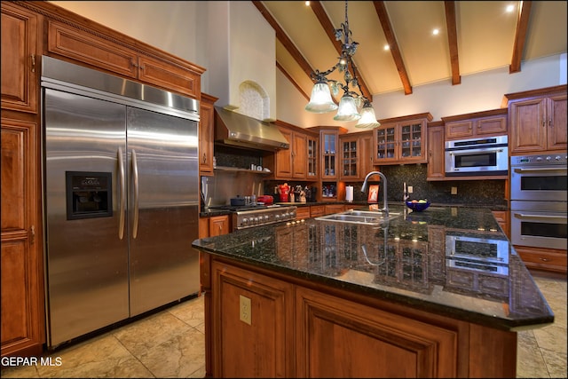 5401 Tierra Vista Dr, El Paso, TX 79932 - kitchen featuring stainless steel appliances, backsplash, a sink, beam ceiling, and a center island with sink