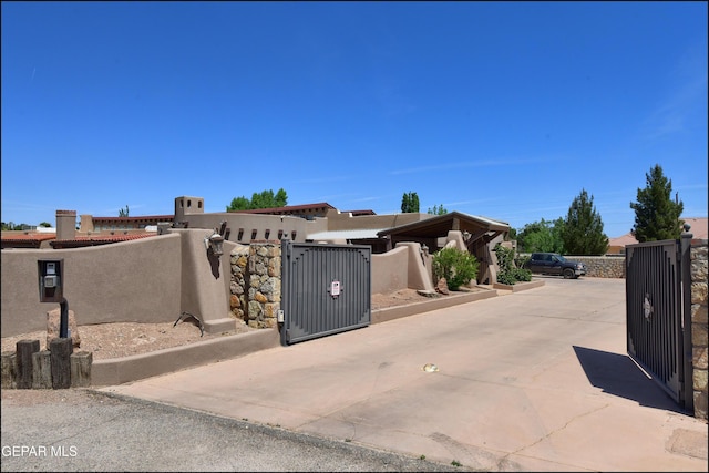 5401 Tierra Vista Dr, El Paso, TX 79932 - view of property exterior featuring a gate, a fenced front yard, and stucco siding