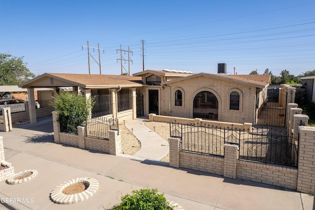 4808 Sagittarius Ave, El Paso, TX 79924 - view of front of home with a gate, a fenced front yard, and brick siding