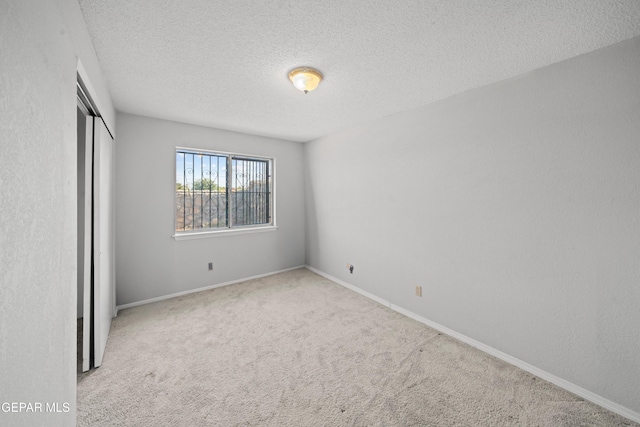 4808 Sagittarius Ave, El Paso, TX 79924 - unfurnished bedroom featuring carpet floors, baseboards, a closet, and a textured ceiling