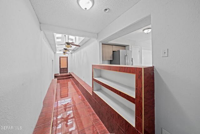 4808 Sagittarius Ave, El Paso, TX 79924 - hallway featuring tile patterned flooring and a textured ceiling