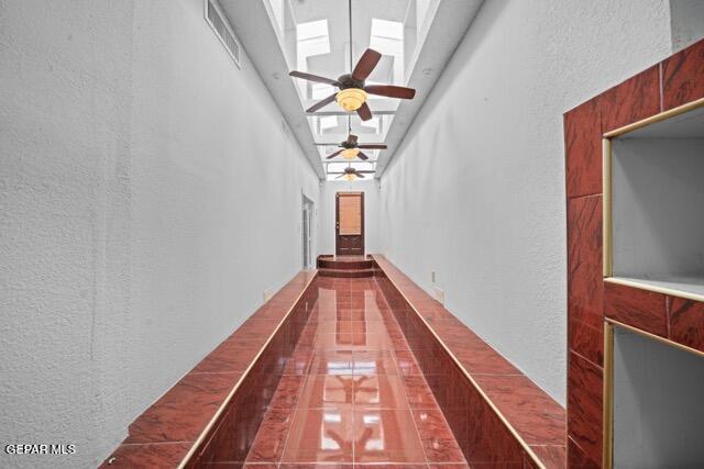 4808 Sagittarius Ave, El Paso, TX 79924 - hallway featuring a skylight, a textured wall, and visible vents