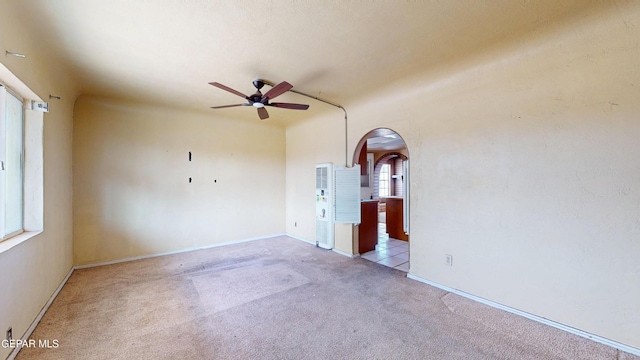 6001 Canton Ct, El Paso, TX 79905 - unfurnished room featuring arched walkways, baseboards, a ceiling fan, and carpet flooring