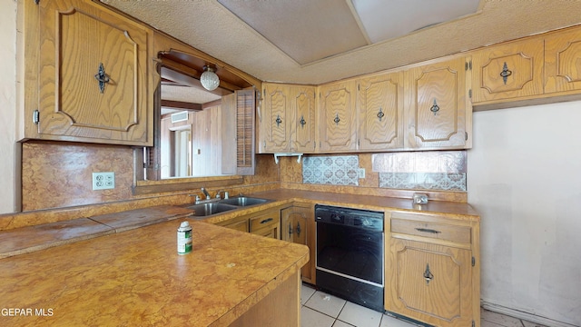 6001 Canton Ct, El Paso, TX 79905 - kitchen with backsplash, dishwasher, a sink, light tile patterned floors, and light countertops