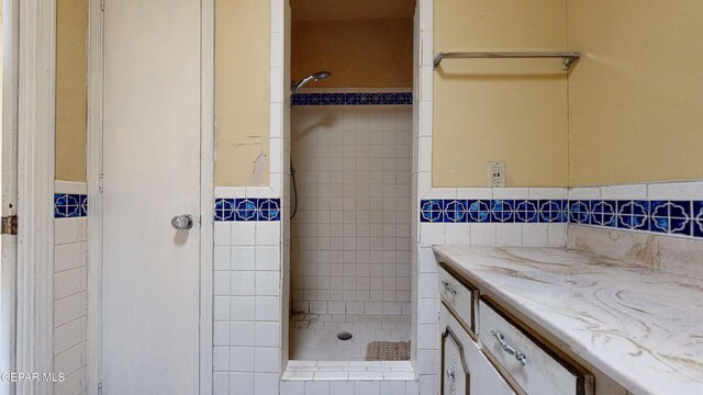 6001 Canton Ct, El Paso, TX 79905 - bathroom featuring vanity, tile walls, and a shower stall