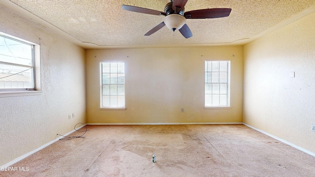 6001 Canton Ct, El Paso, TX 79905 - carpeted empty room with baseboards, a textured ceiling, a textured wall, and a wealth of natural light