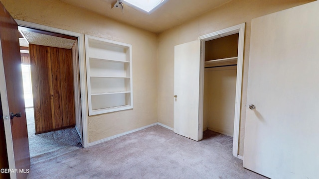 6001 Canton Ct, El Paso, TX 79905 - unfurnished bedroom featuring a closet, baseboards, a skylight, and carpet flooring