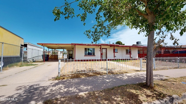 6001 Canton Ct, El Paso, TX 79905 - view of front of home featuring a fenced front yard, stucco siding, driveway, and an attached carport