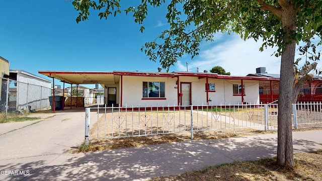 6001 Canton Ct, El Paso, TX 79905 - view of front of home with a carport, a fenced front yard, and driveway