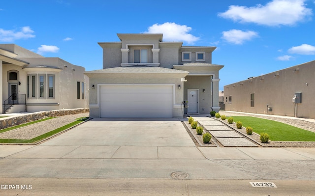 view of front of home featuring an attached garage, stucco siding, and driveway