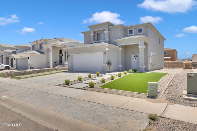 view of front of property with fence, stucco siding, driveway, and a front yard