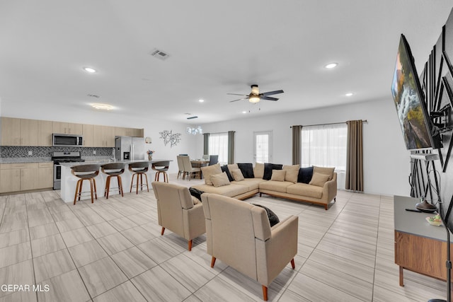 living area featuring ceiling fan, recessed lighting, and visible vents