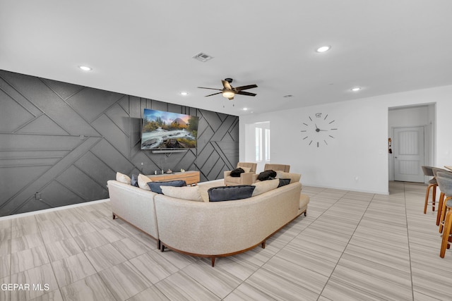 living room featuring light tile patterned floors, a ceiling fan, recessed lighting, and visible vents