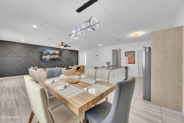 dining space with recessed lighting, ceiling fan, light tile patterned floors, and an accent wall