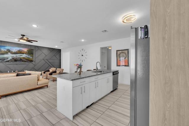 kitchen featuring ceiling fan, appliances with stainless steel finishes, a sink, white cabinets, and recessed lighting