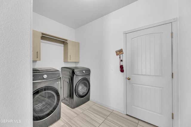laundry area with cabinet space and washer and clothes dryer