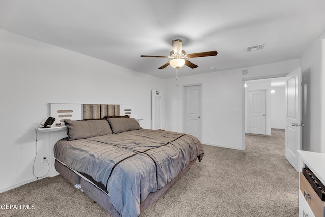 carpeted bedroom featuring baseboards, visible vents, and ceiling fan