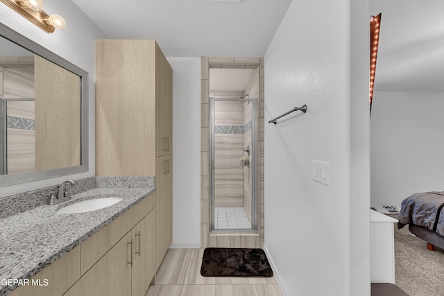 ensuite bathroom with vanity, ensuite bathroom, and a stall shower