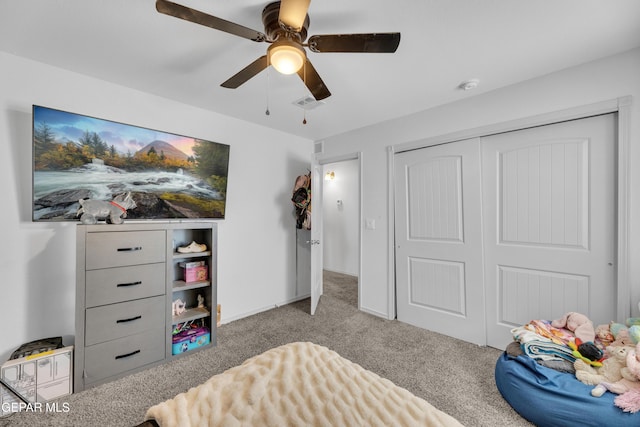 carpeted bedroom featuring a ceiling fan, visible vents, and a closet